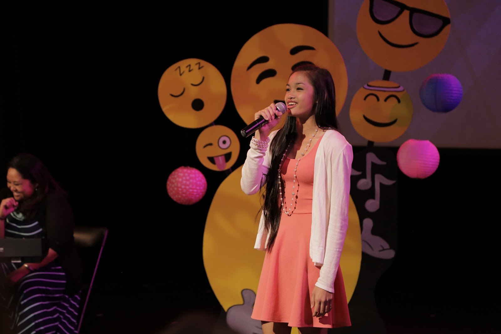 A young PDD voice student singing into a microphone